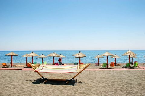 Perivolos black sandy beach